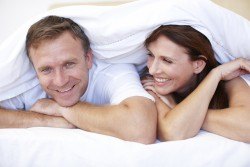 Man and Woman Under Sheets