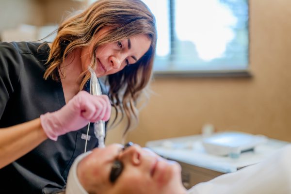 Aesthetician performing microneedling